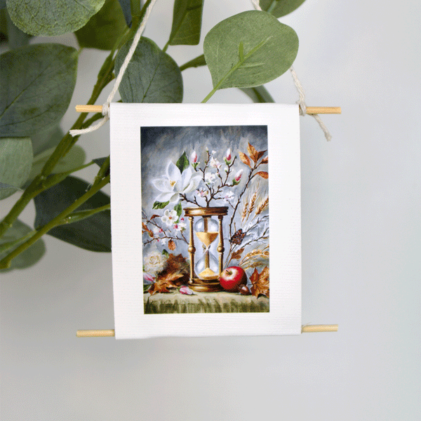 Mini collectible art featuring an hourglass surrounded by flowers, wheat, and fruit — A Time for Everything by Mindi Oaten, symbolizing God’s perfect timing.