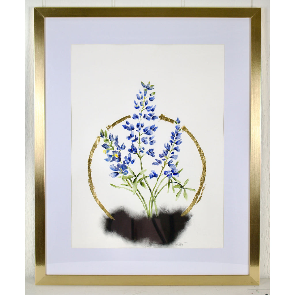 Framed artwork of blue flowers with a gold border