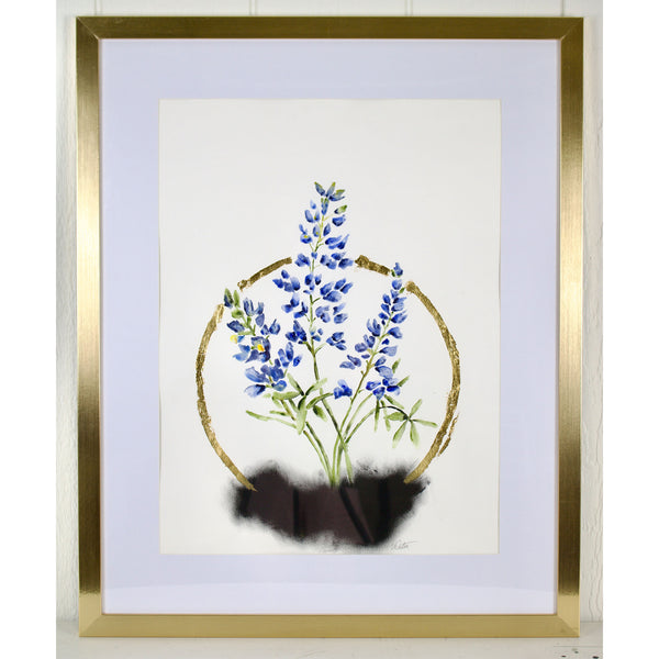 Framed artwork of blue flowers with a gold border