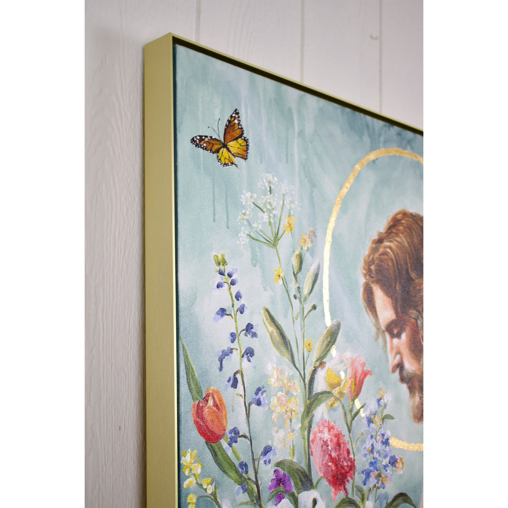 Framed artwork with a depiction of a person, flowers, and a butterfly on a light blue background.