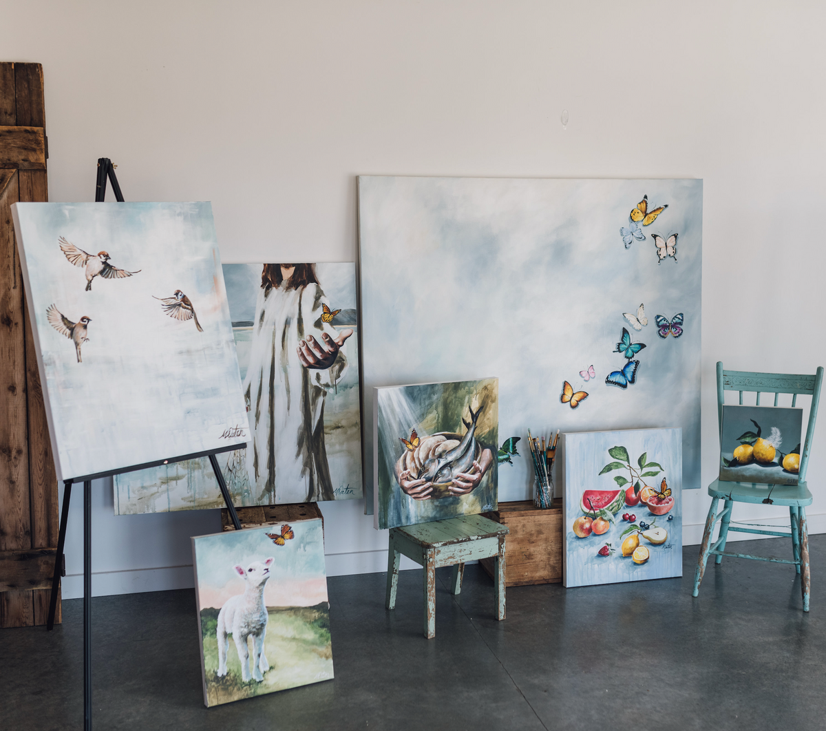 
Collection of original paintings by Christian fine artist Mindi Oaten displayed together in the studio