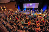 

An audience gathered in a worship space during a live painting event.
