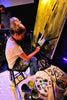 

Mindi painting a garden-spade artwork during a live gathering.