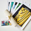 

Colorful canvas prints beside a tied canvas roll and information card.