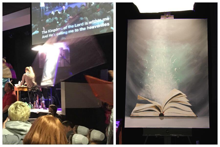 

Mindi painting an open book during a gathering, beside the completed artwork.